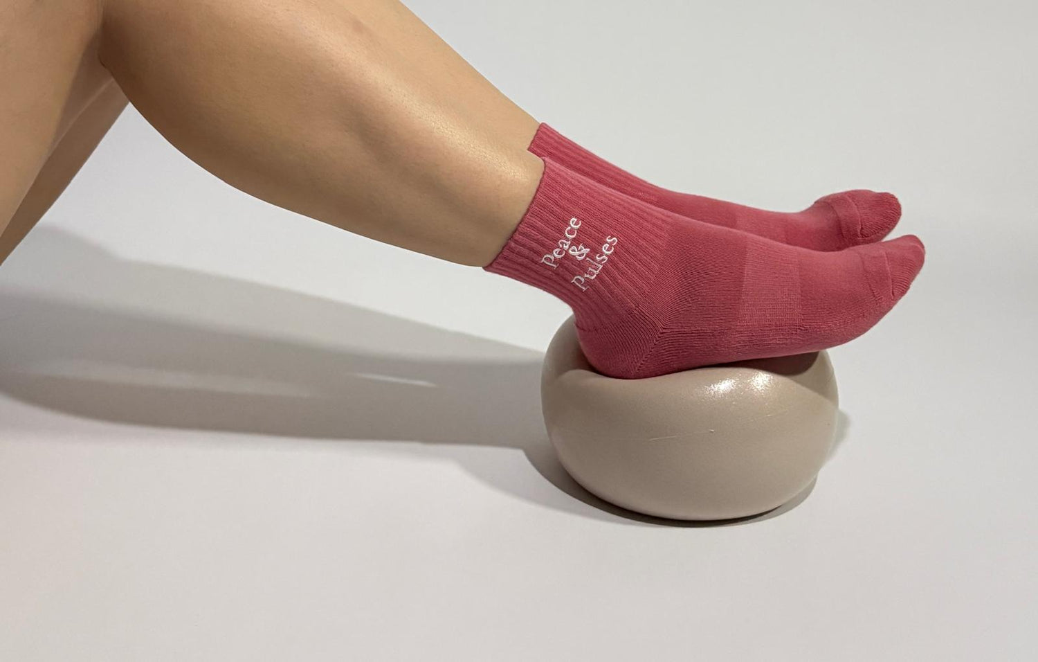 Peace & Pulses breathable grip socks worn by a person during a Pilates exercise showing the comfort and stability of the socks