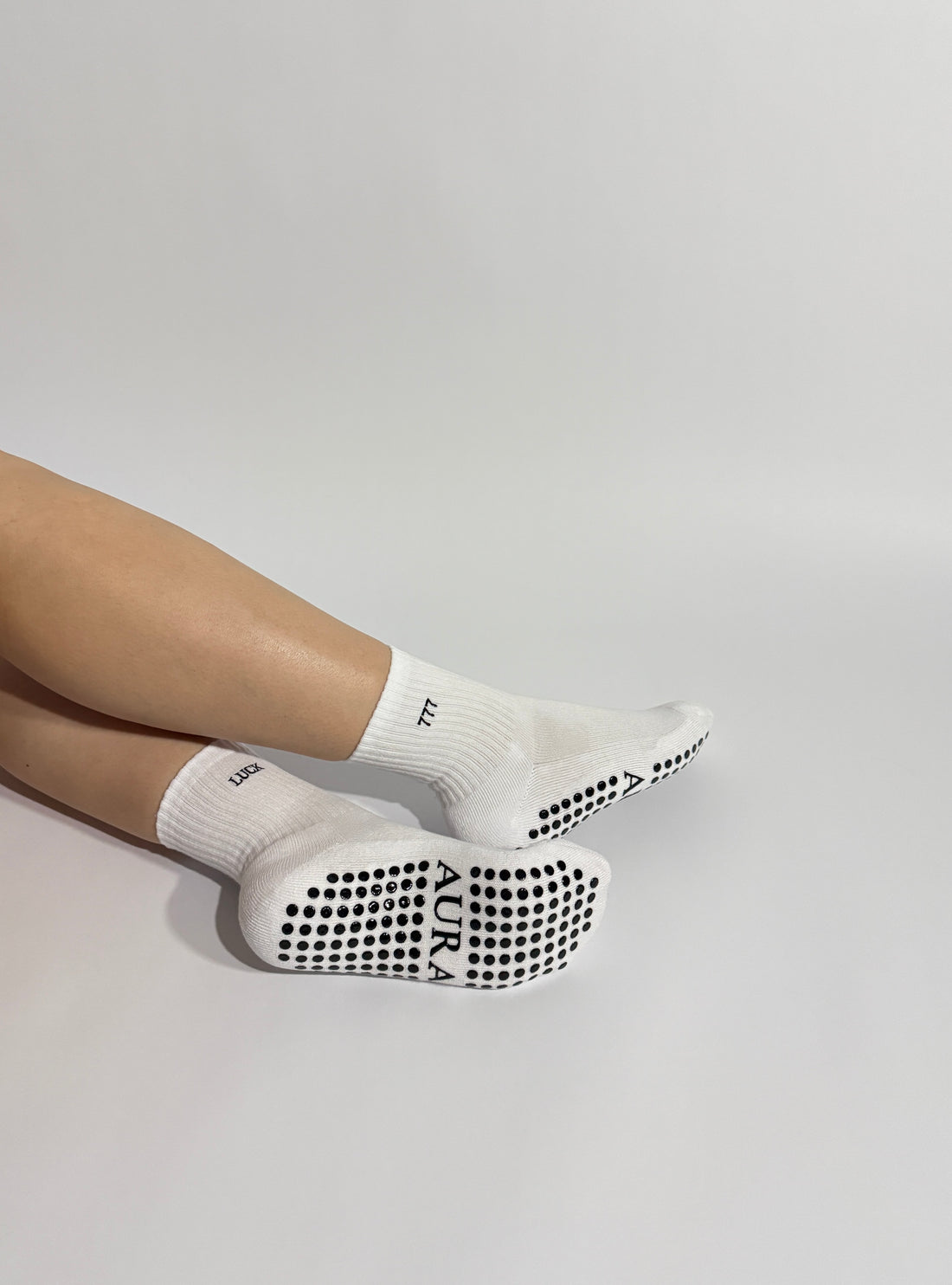 Close up 777 Pilates grip socks with AURA logo showing premium design