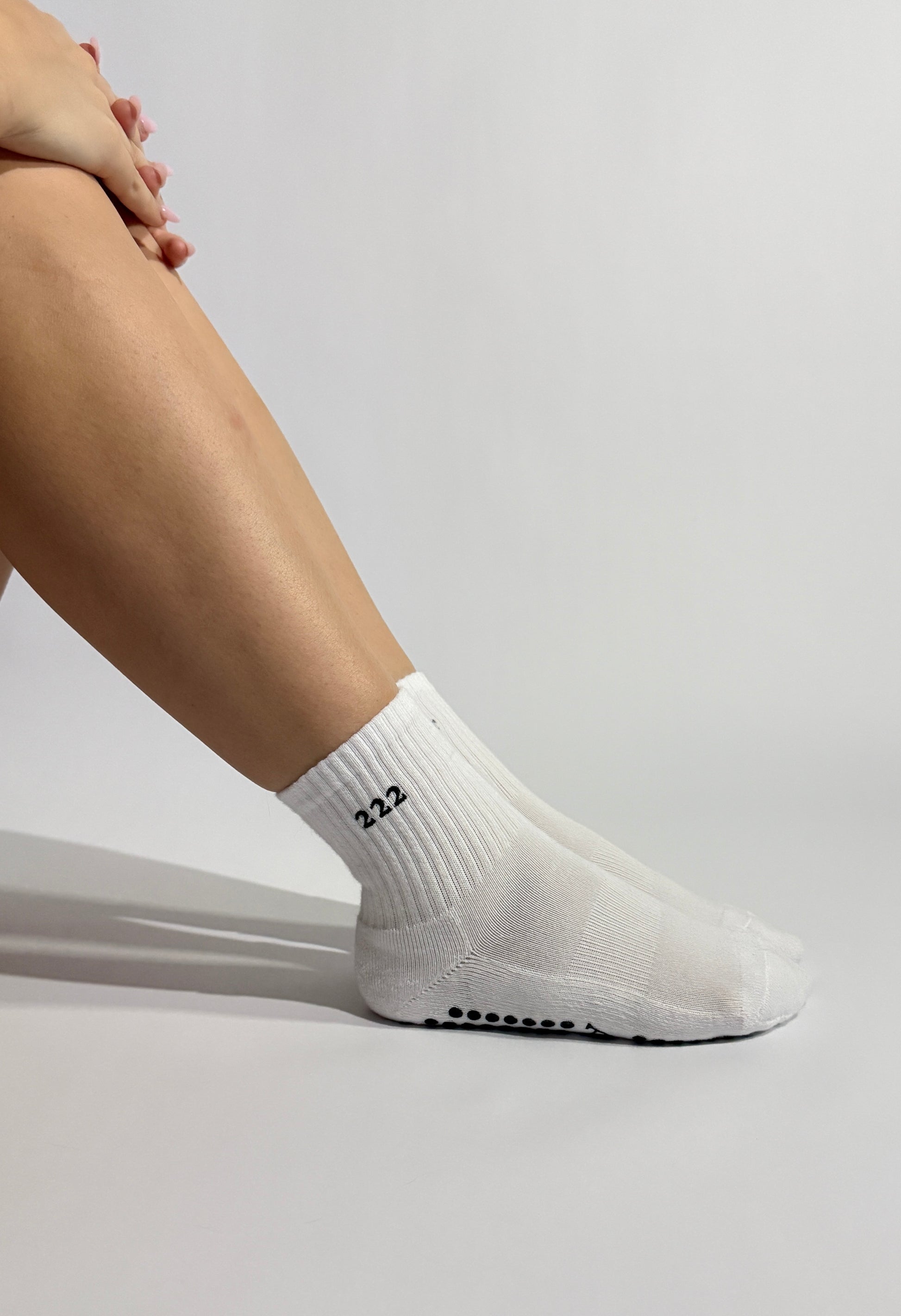 Aesthetic and minimalist close up on a white 222 Pilates grip socks