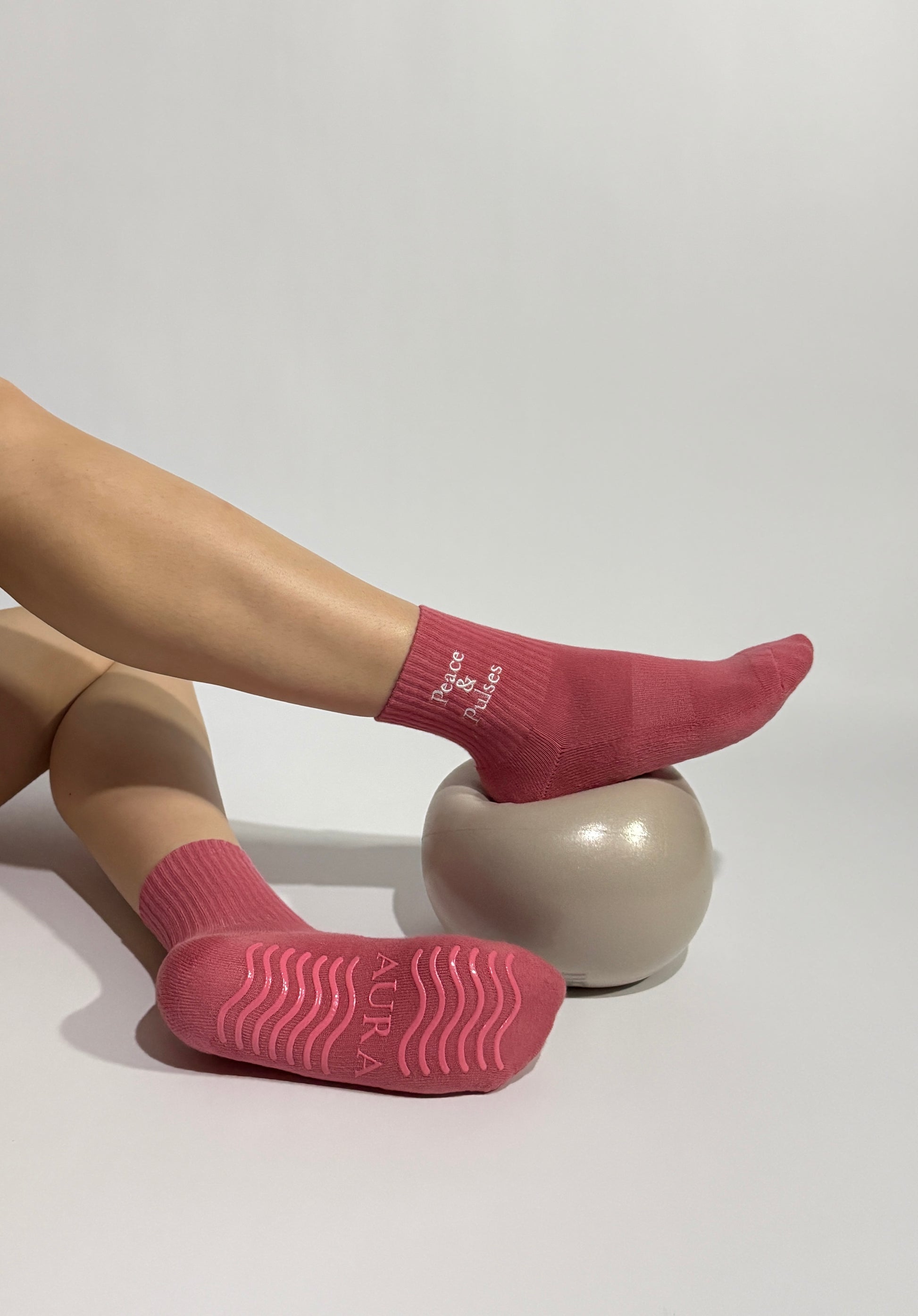 Peace & Pulses Pilates grip socks worn during a Pilates exercise