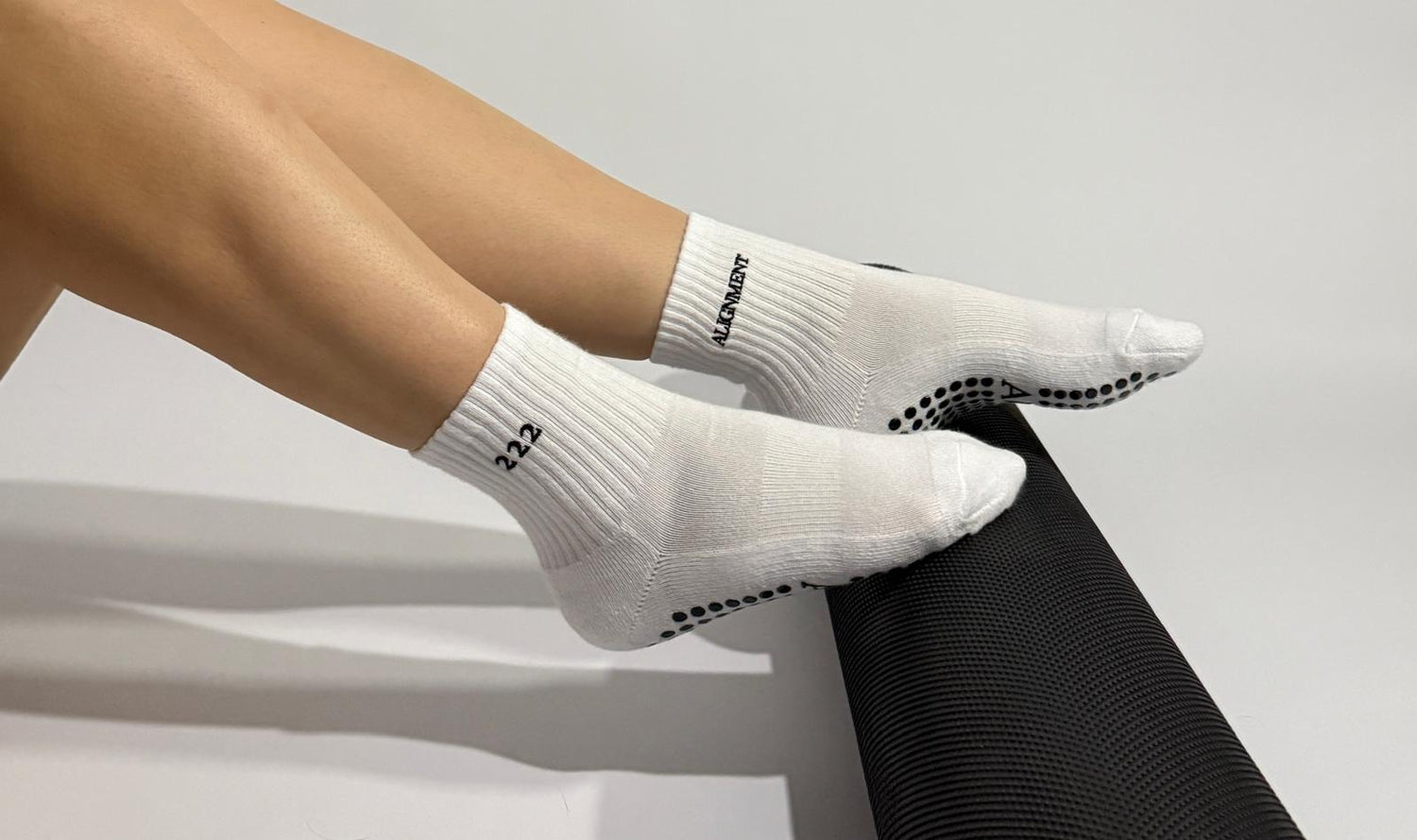 22 angels number white Pilates grip socks worn by a person during an exercise in a Studio in Switzerland